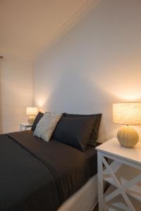 a bedroom with a bed and two tables with lamps at Dartmouth Hotel Pub in Dartmouth