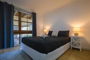 a bedroom with a bed with two speakers on it at Dartmouth Hotel Pub in Dartmouth