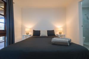 a bedroom with a large bed with two lamps at Dartmouth Hotel Pub in Dartmouth