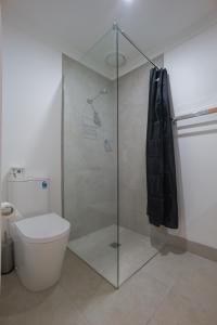 a bathroom with a toilet and a glass shower stall at Dartmouth Hotel Pub in Dartmouth