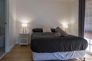 a bedroom with a bed with two lamps on it at Dartmouth Hotel Pub in Dartmouth