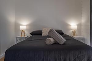 a bedroom with a bed with two lamps on it at Dartmouth Hotel Pub in Dartmouth