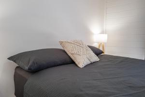 a bed with two pillows on top of it at Dartmouth Hotel Pub in Dartmouth
