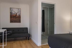 a bedroom with a bed and a glass shower at Dartmouth Hotel Pub in Dartmouth