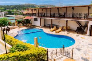 a large swimming pool in front of a building at Hotel Casona del Virrey in Moniquirá