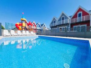 a swimming pool with a water slide and a playground at Cottage in Sarbinowo near Seaside Beach in Sarbinowo