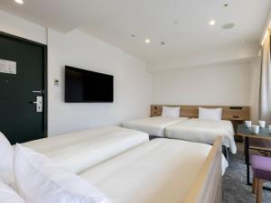 Postel nebo postele na pokoji v ubytování Tokyu Stay Shibuya Shin-Minamiguchi