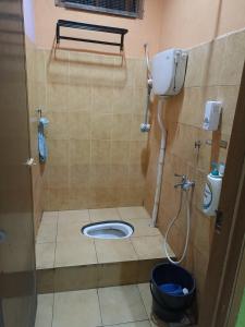a small bathroom with a toilet in a stall at Husna Homestay Kota Harmoni Tanah Merah in Tanah Merah