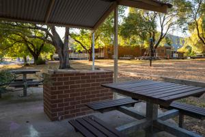 a picnic shelter with a picnic table in a park at Dartmouth Hotel Pub in Dartmouth