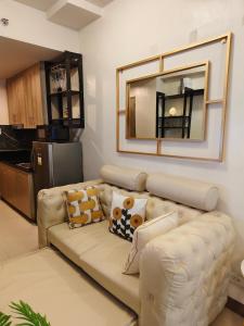 a living room with a couch and a mirror at City Serenity Escape in Manila +24 photos