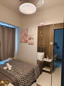 a hotel room with a bed and a lamp at City Serenity Escape in Manila