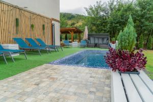 a backyard with a swimming pool and blue chairs at Montana 219 in Valea Drăganului