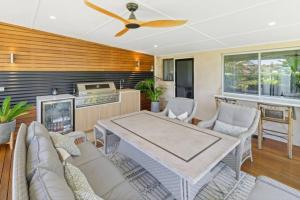 a living room with a couch and a table at Luxury Spa Beachfront Moana in Moana +10 photos