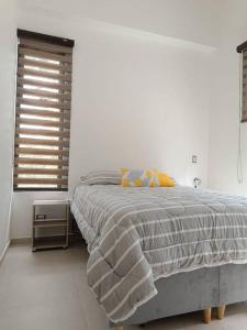 a white bedroom with a bed and a window at Avemaría! in Puente Nacional +16 photos