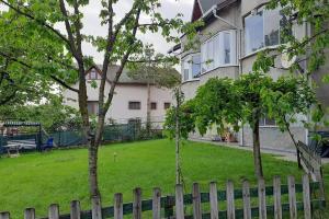 a yard with two trees in front of a house at Bahceli ev 