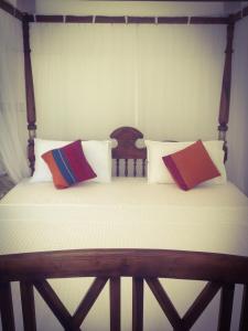 łóżko z dwoma poduszkami na górze w obiekcie Mirissa Seastar w mieście Mirissa