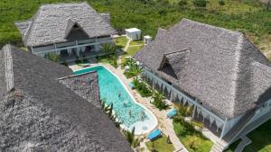 an aerial view of a house with a swimming pool at Cacuki Boutique House in Watamu