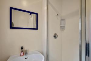 a bathroom with a sink and a shower and a mirror at Bayview Beauty - Charteris Bay Holiday Home in Diamond Harbour +22 photos