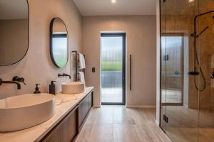a bathroom with two sinks and a shower at Sky High Retreat in Nelson +34 photos