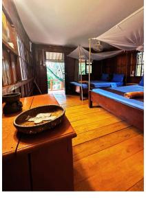 a room with a table and a bed in a tent at Mangrove Beach Bungalows in Koh Rong Sanloem