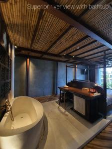 a bath tub in a room with a piano at MINH - CASA in Hoi An +45 photos