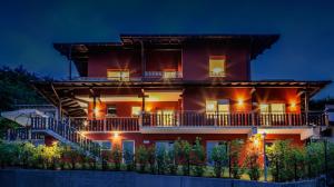 a large apartment building with a balcony at night at Artemide Relais in Montebelluna
