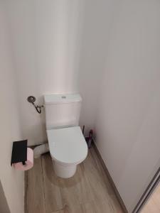 a white toilet in a bathroom with a wooden floor at Jauxvial 1 in Jaux +15 photos