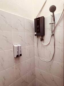 a shower with a blow dryer in a bathroom at RumaRosa Kota Bharu in Kota Bharu