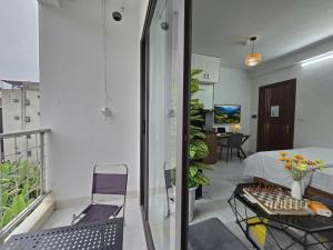a room with a balcony with a bed and a table at Cygnus Homestay Ha Noi 89 in Hanoi