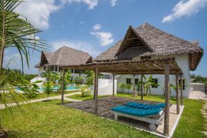 a wooden deck in front of a villa at Cacuki Boutique House in Watamu