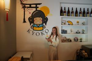 a woman standing in front of a wall with a painting of a girl at AG Hotel in Abu Dhabi +117 photos