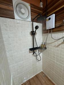 a shower with a shower head in a bathroom at The Canyon KhaoYai By Campx in Ban Tha Chang