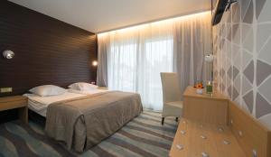 Postel nebo postele na pokoji v ubytování Hotel Maxim