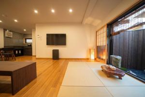 a living room with a large window and a tv at 御屋 稲 in Kyoto