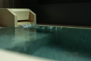 a swimming pool with water coming out of it at 御屋 稲 in Kyoto
