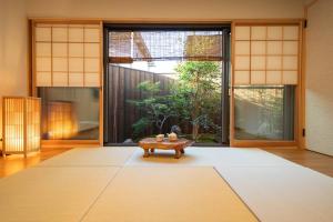 a living room with a table in the middle of a room at 御屋 稲 in Kyoto