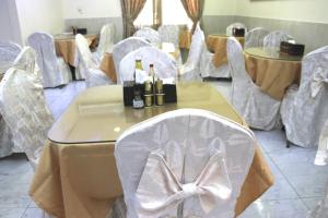 a room with chairs and a table with bottles of champagne at Al Ahrar Hotel in Dubai