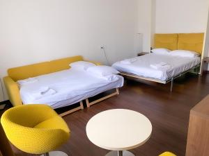 クランにあるResidence Caddies Clubのテーブルと椅子のある部屋にベッドが2つある +21枚の写真