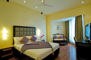 a bedroom with a large bed and a large window at The Gateway Hotel Marine Drive, Ernakulam in Cochin