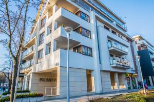 a building with a street light in front of it at Apartment Extra Home in Kielce