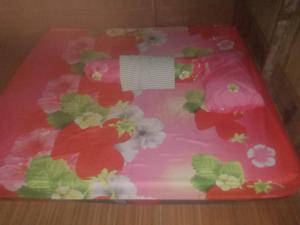 a pink cake with flowers on top of it at Nyandetor Homestay in Yennanas Besir +36 photos