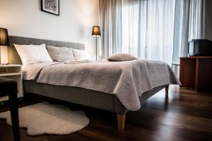 a bedroom with a bed and a window at Apartment Extra Home in Kielce