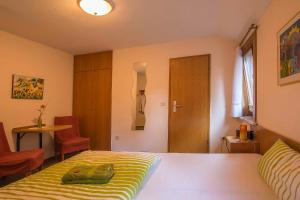 a bedroom with a bed and a table and a chair at Pension Haus Brückner in Wildemann +14 photos