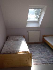 a small bedroom with a bed and a window at Ferienwohnung "Haus Tanneck" in Clausthal-Zellerfeld