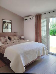 Posteľ alebo postele v izbe v ubytovaní Apartments Divna