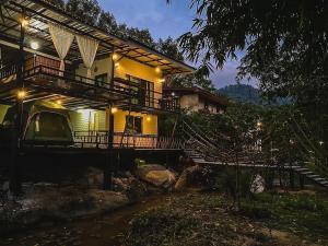 a house with a staircase leading up to it at บ้านชมธาร บ้านสวนสราญชล in Ban Plai Nam (2)