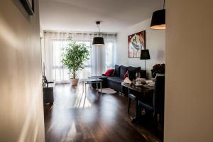 a living room with a couch and a table at Apartment Extra Home in Kielce
