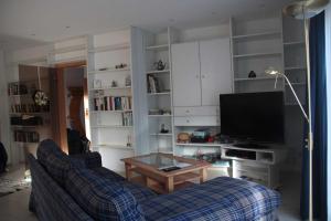 a living room with a couch and a tv at Ferienhaus Arnold in Goslar