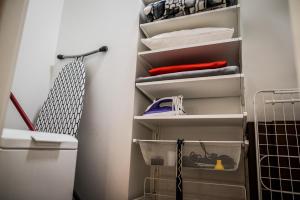 a walk in closet with white shelves at Apartment Extra Home in Kielce +56 photos