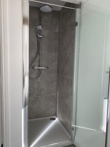 a shower with a glass door in a bathroom at The Cow Shed at Bank Farm in Yeovil +9 photos